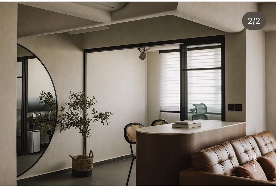 Curved timber console behind a leather sofa, doubling as a study counter, from ChengYi's portfolio