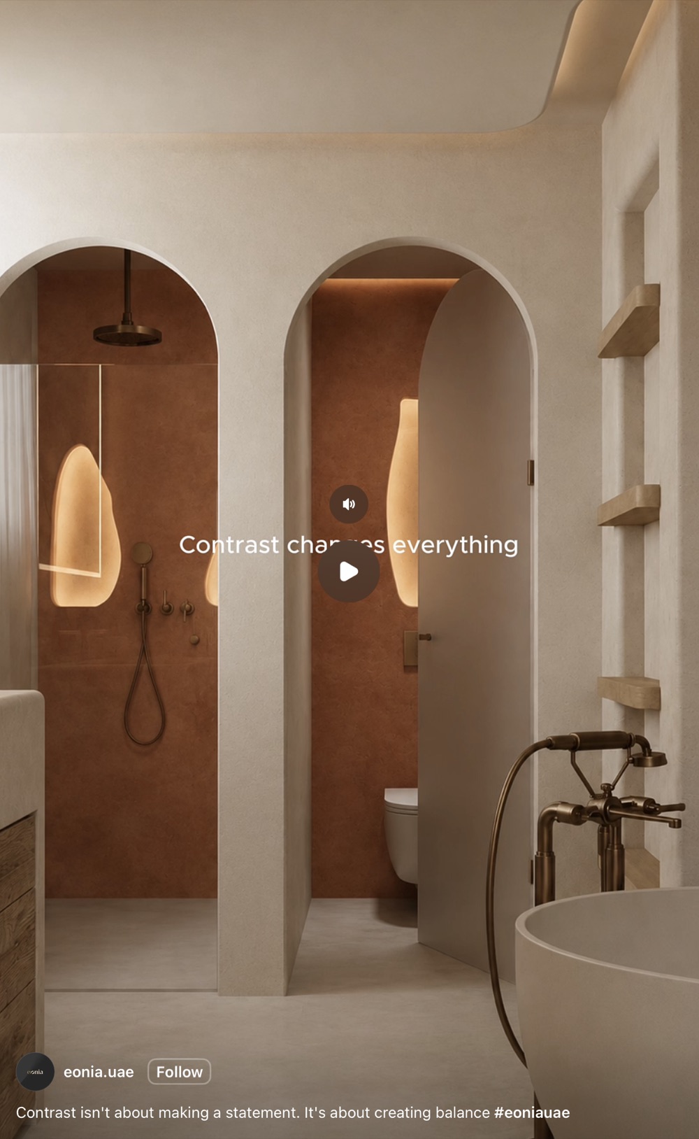 Bathroom with pale limewash arches opening onto terracotta-red wet areas, brass fittings