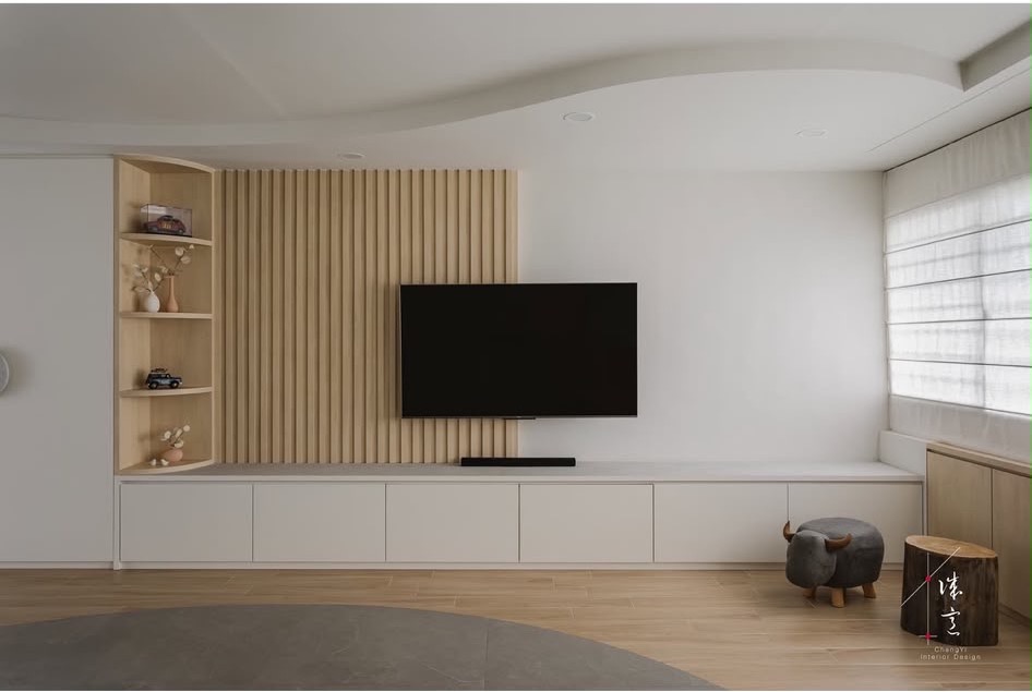Feature wall with fluted oak on one half and bare white wall on the other, low white cabinets running the full width, from ChengYi's portfolio
